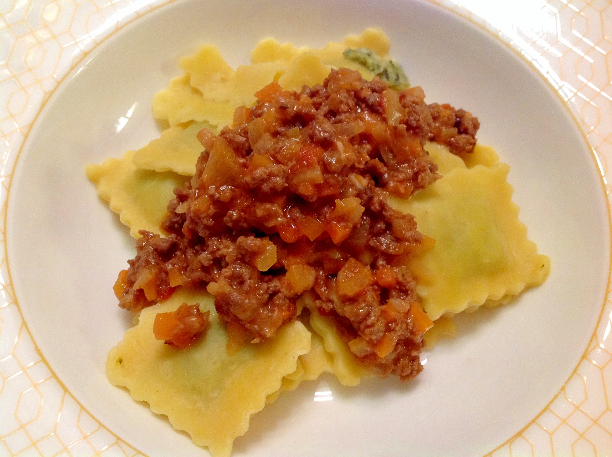 白いお皿に盛り付けられたミートソースがのったラビオリ