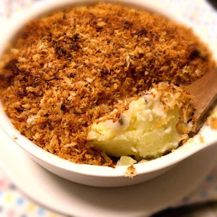 器に入ったコーンクリームのスコップコロッケをスプーンですくっている様子