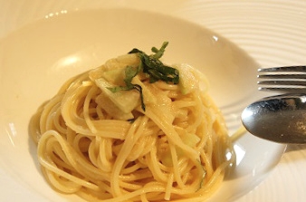 白い丸皿に盛り付けたスイカの皮と大葉の冷製パスタ