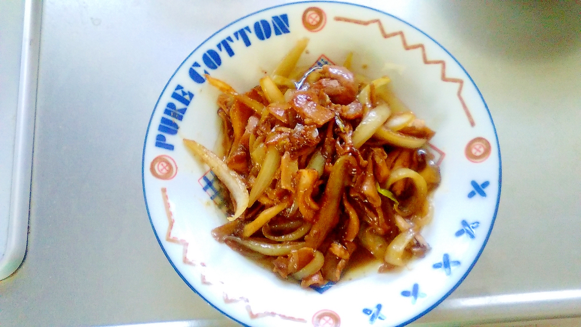 白い皿に盛り付けた豚ホルモンと野菜の炒め物