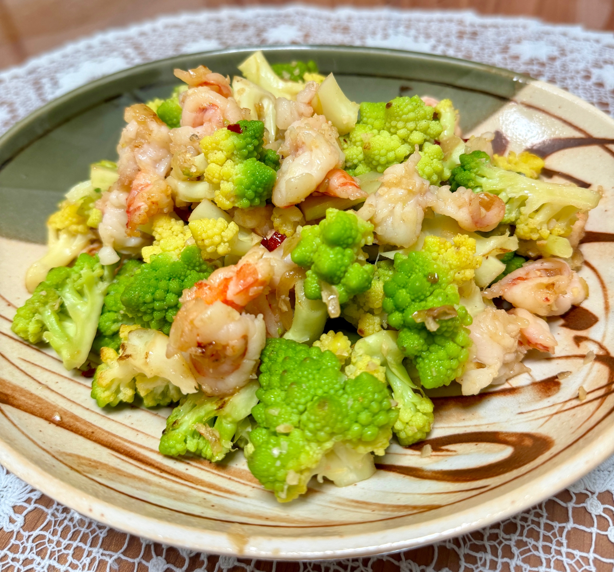 陶器の皿に入ったえびとカリッコリーのペペロンチーノ