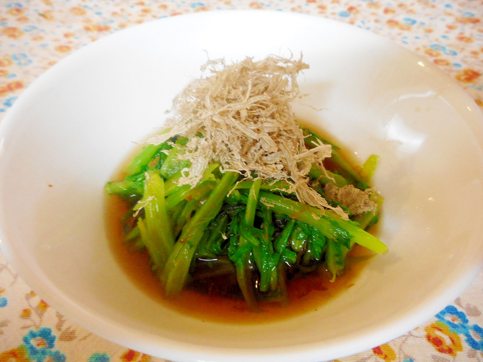 白い皿に盛り付けた春菊のおひたしとろろ昆布のせ