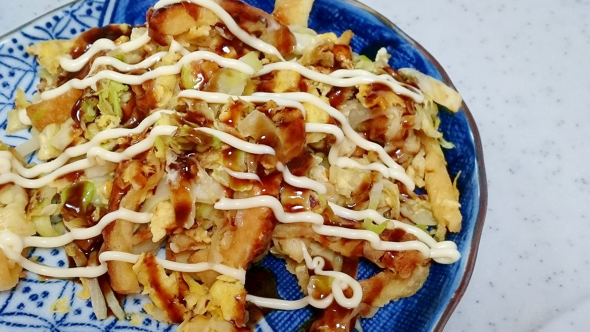 青い皿に盛られた、お好み焼き風卵焼き