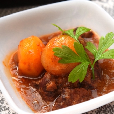 白い皿に盛り付けた牛肉のサルチャ煮込み