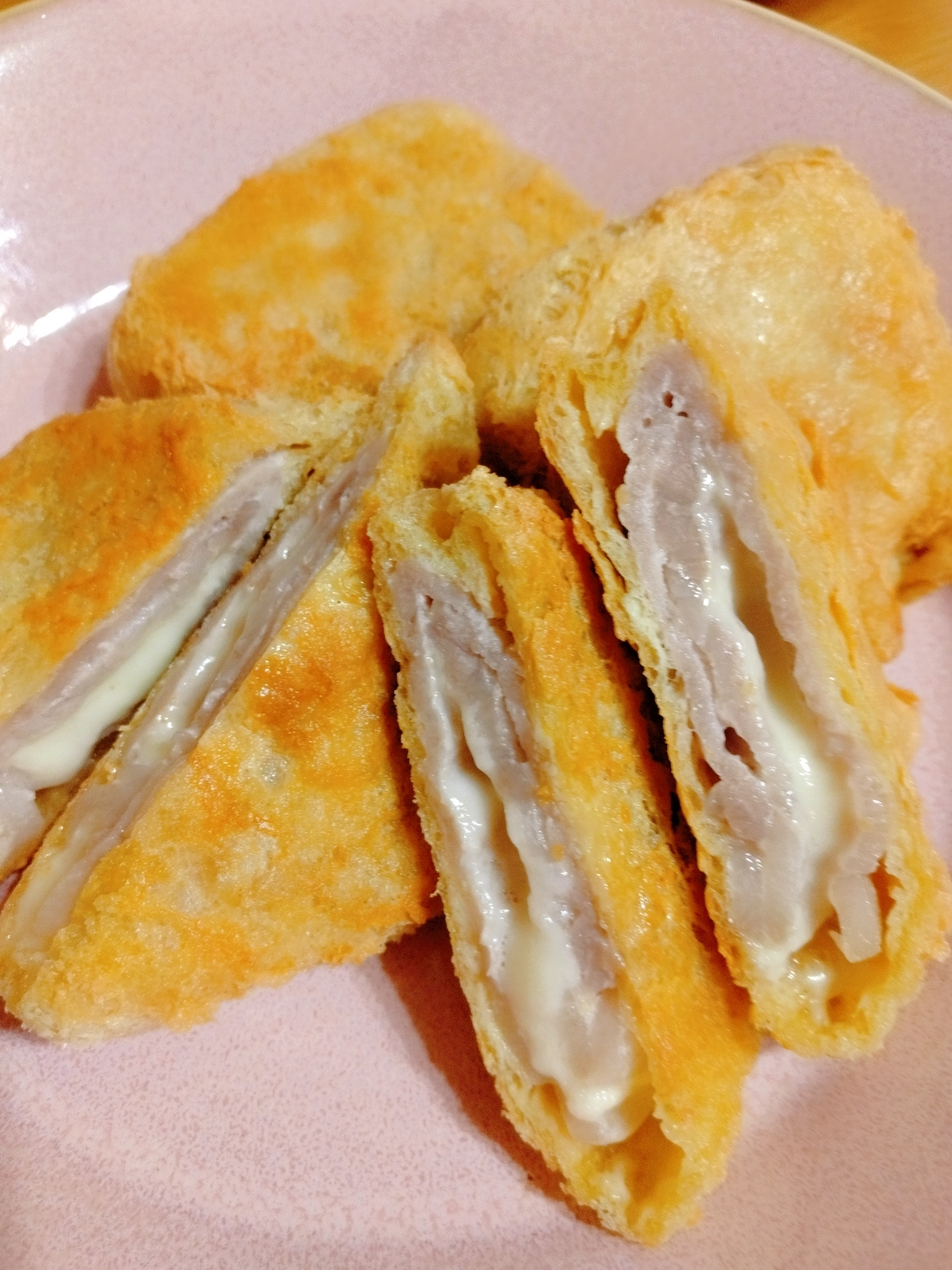 ピンクのお皿に盛り付けられたお揚げ衣のチーズとんかつ